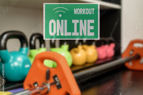 workout sign online, hall closed due to quarantine. Set of colorful iron modern kettlebbells on rack in gym