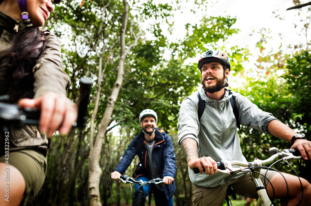 Fototapeta premium Group of friends ride mountain bike in the forest together