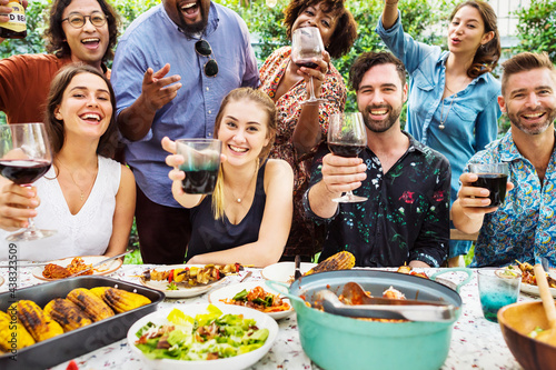 Group of diverse friends enjoying summer party together photo