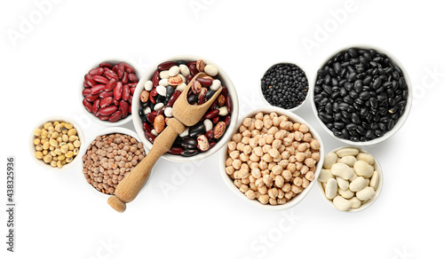 Bowls with different legumes on white background