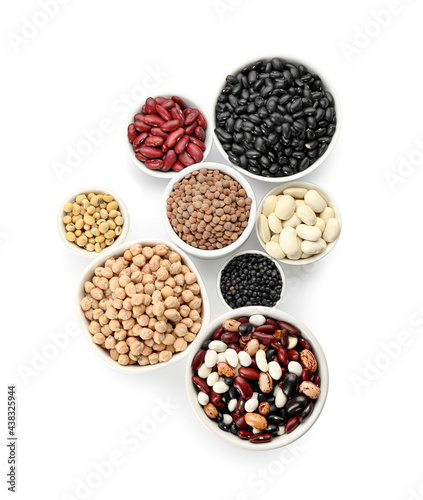 Bowls with different legumes on white background