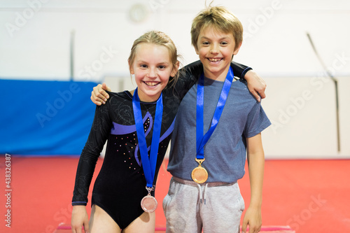 Young gymnasts with their medals photo