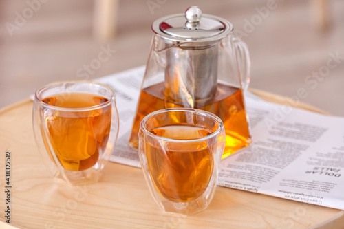 Teapot and cups of hot beve...