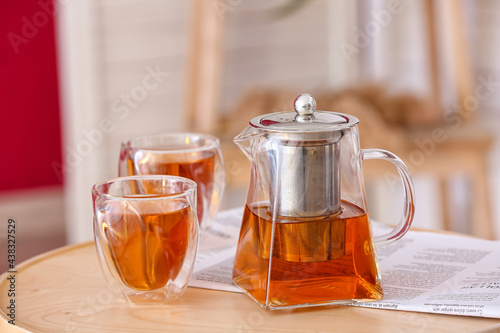 Teapot and cups of hot beve...