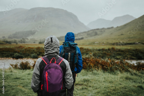 Couple trekking through the rain in the Highlands