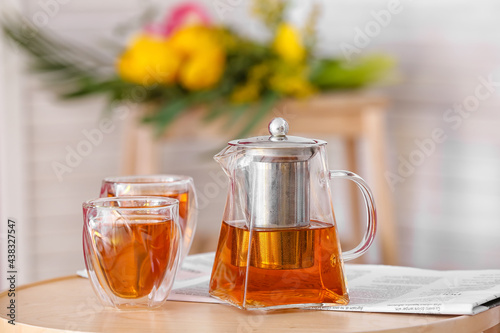 Teapot and cups of hot beve...