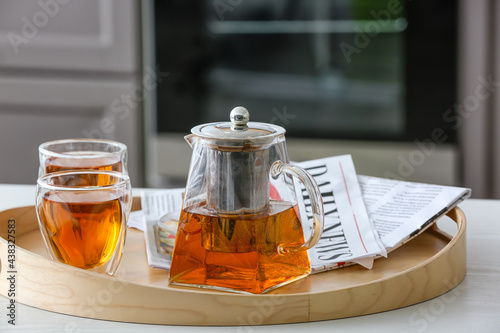 Teapot and cups of hot beve...