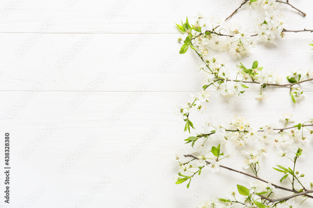 Beautiful blooming branches on light wooden background Beautiful blooming branches on light wooden background