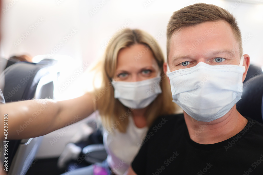 Portrait of man and woman in medical protective mask in public transport