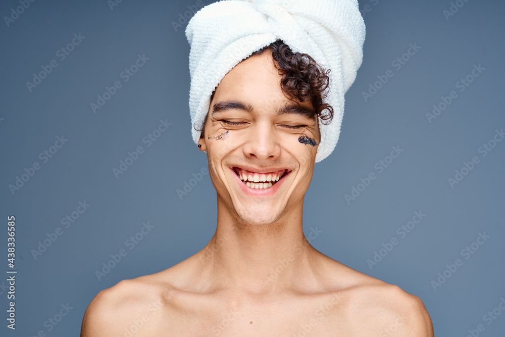 man with bare shoulders towel on head cream clean skin cosmetology man with bare shoulders towel on head cream clean skin cosmetology