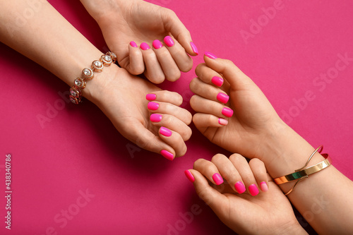 Women with beautiful manicure on color background