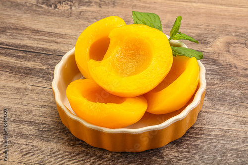 Sweet ripe canned peaches with mint