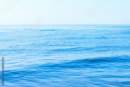 Deep blue and rough sea with lot of sea spray.Blue background.Soft focus,blurred image.
