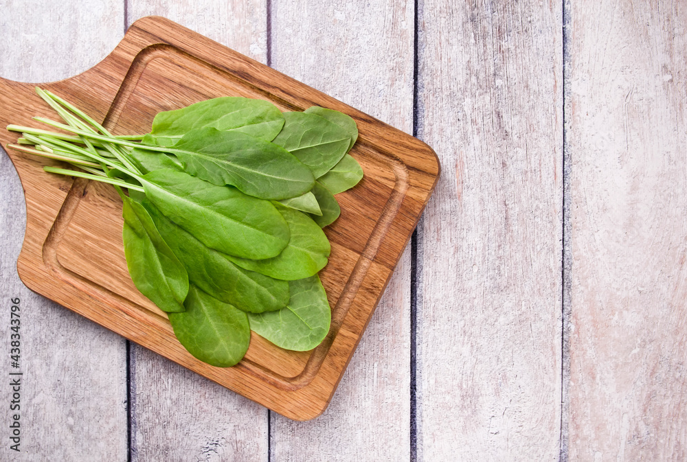 Fresh organic sorrel, on wooden table for spring green vegetables soup and salad. Fresh organic sorrel, on wooden table for spring green vegetables soup and salad.
