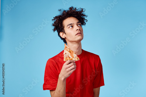 guy where is he and hair in a red t-shirt with a slice of pizza on a blue background