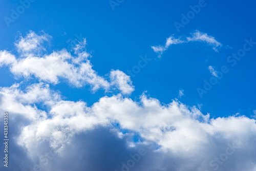 Dramatic blue sky with white clouds background.