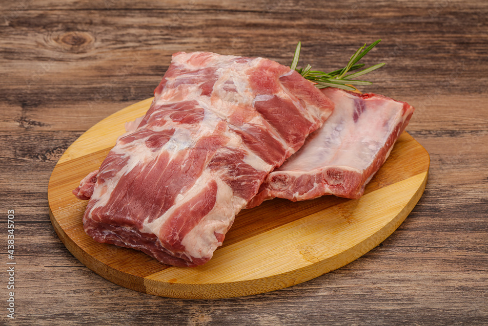 Raw pork ribs served rosemary