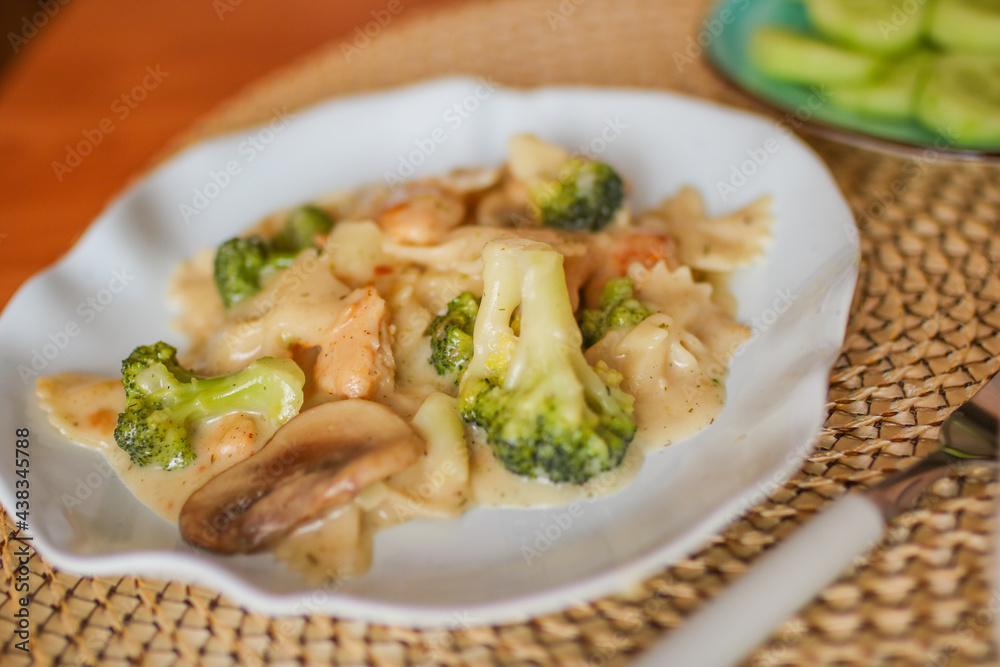 Roasted chicken mushroom pepper pasta in a white plate. toning. selective focus Roasted chicken mushroom pepper pasta in a white plate. toning. selective focus