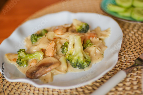 Roasted chicken mushroom pepper pasta in a white plate. toning. selective focus