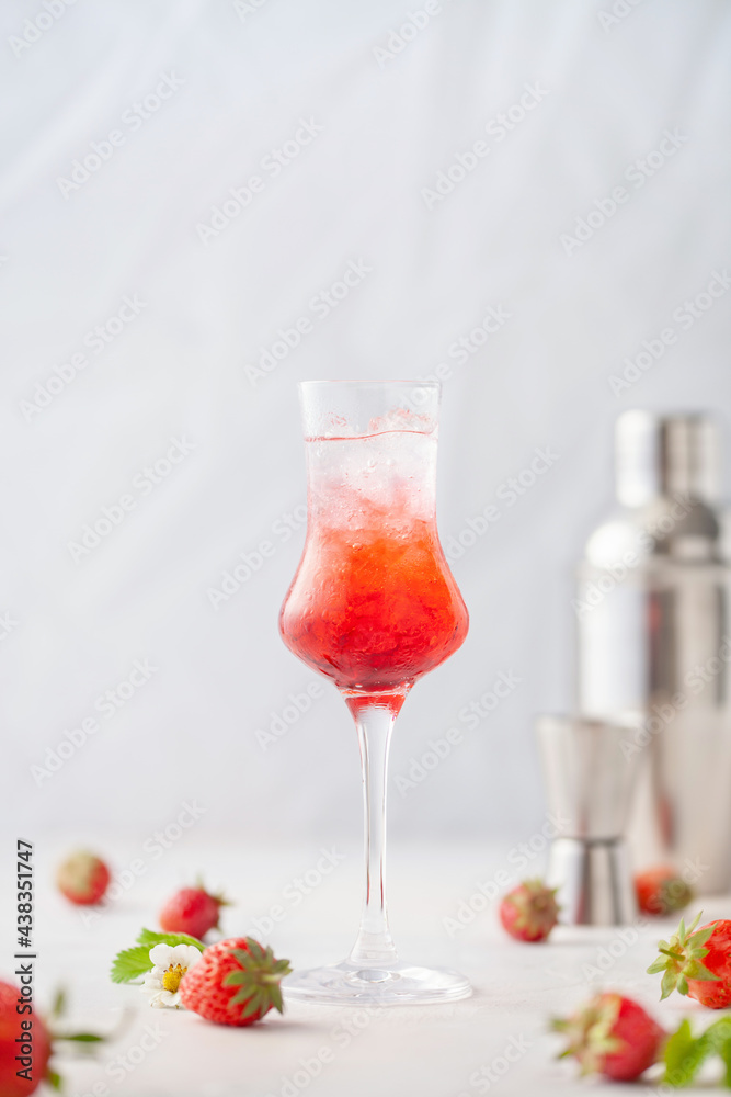 Strawberry liqueur with ice in a glass. Summer refreshing alcoholic drink Strawberry liqueur with ice in a glass. Summer refreshing alcoholic drink