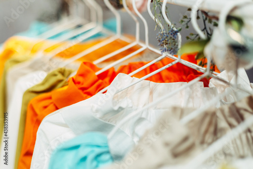 Light craft vintage summer dresses hanging on hangers in the store