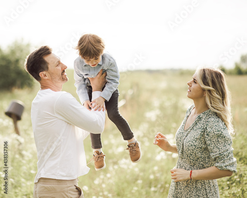 Young couple adopted a little boy 3 years old. They are happy together. Adoption concept