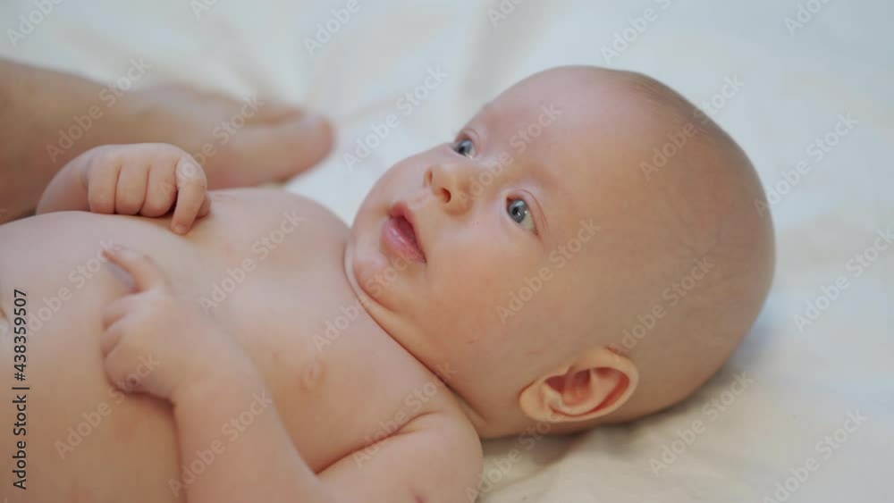 Mother massage 3 months old baby boy gently ppressing, rubbing parts of infant body, relax baby. High quality 4k footage Mother massage 3 months old baby boy gently ppressing, rubbing parts of infant body, relax baby. High quality 4k footage