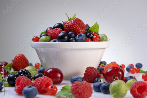 Mix of wild berries on white background
