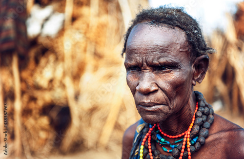 Serious senior woman from Dassanech tribe in a village, Omo vall photo