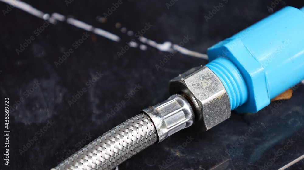 Stainless steel connector for PVC pipe. Flexible connector with plastic pipes of water supply