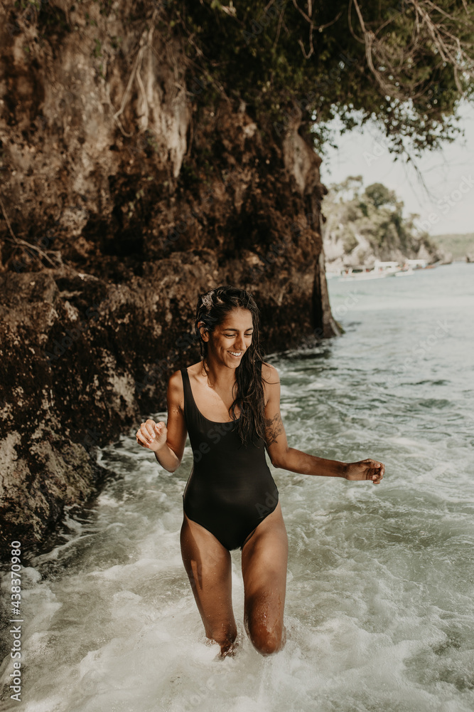 Woman posing in water at seashore Woman posing in water at seashore