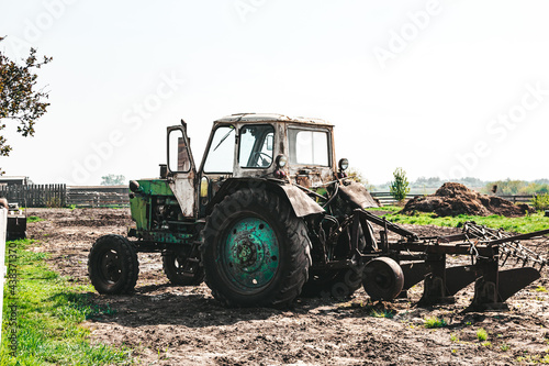 Agricultural seasonal work, a tractor plows the land for sowing seedlings, horizontal photo on a sunny day