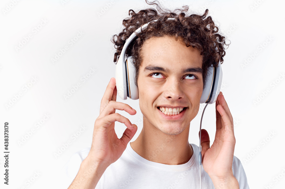 Fototapeta premium happy guy with headphones curly hair emotions close-up