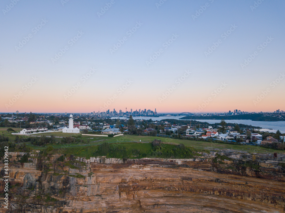 Macquarie Lighthouse and Sydney CBD skyline in the morning with clear sky.