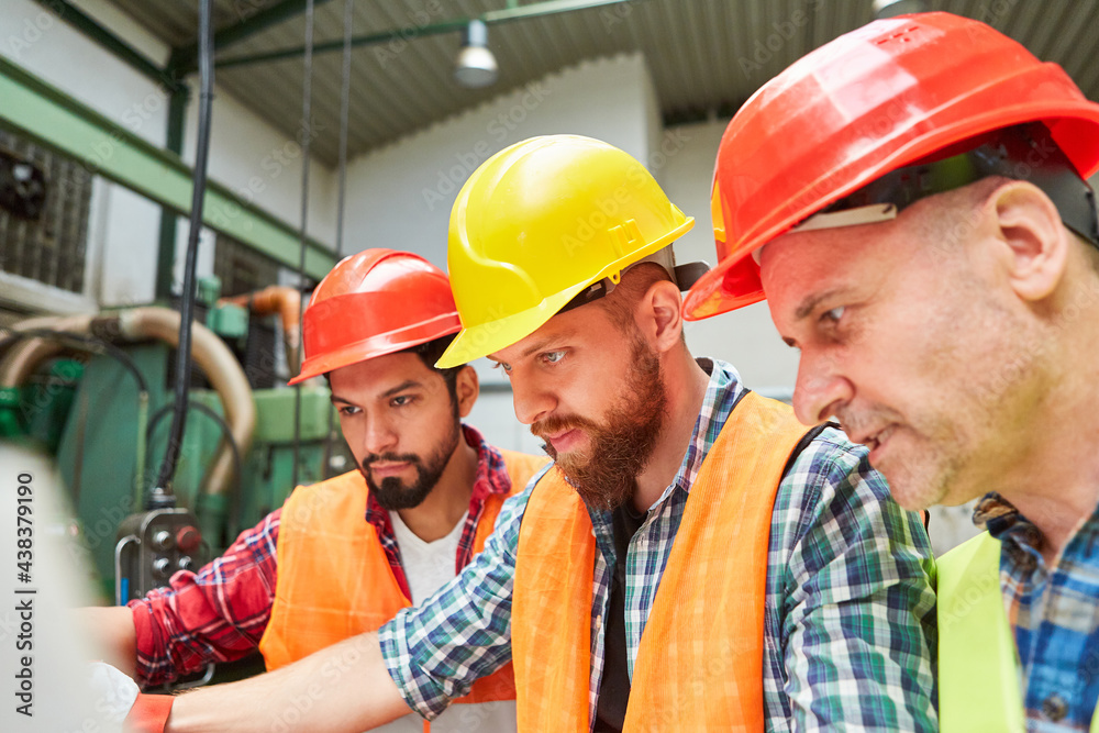Group of metal workers planning in teamwork Group of metal workers planning in teamwork
