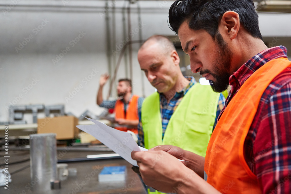 Fotografie Two craftsmen check an order