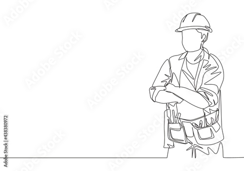 One continuous line drawing of young construction builder wearing uniform, tools belt and helmet while crossing his hands. Craftsman home repair service concept. Single line draw design illustration