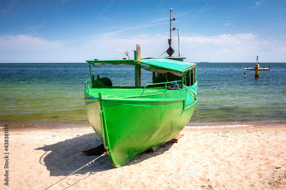 Summer scenery of the Baltic Sea with fishing boat in Gdynia Orlowo, Poland Summer scenery of the Baltic Sea with fishing boat in Gdynia Orlowo, Poland