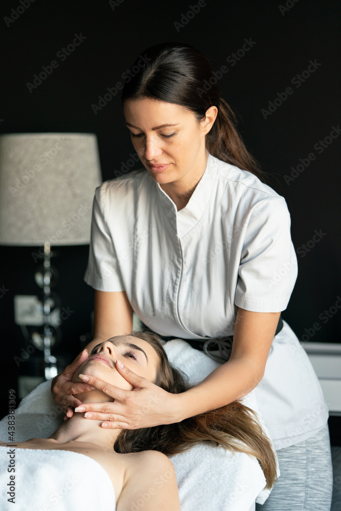 Fototapeta premium Health, beauty, resort and relaxation concept. Beautiful woman in spa salon getting massage
