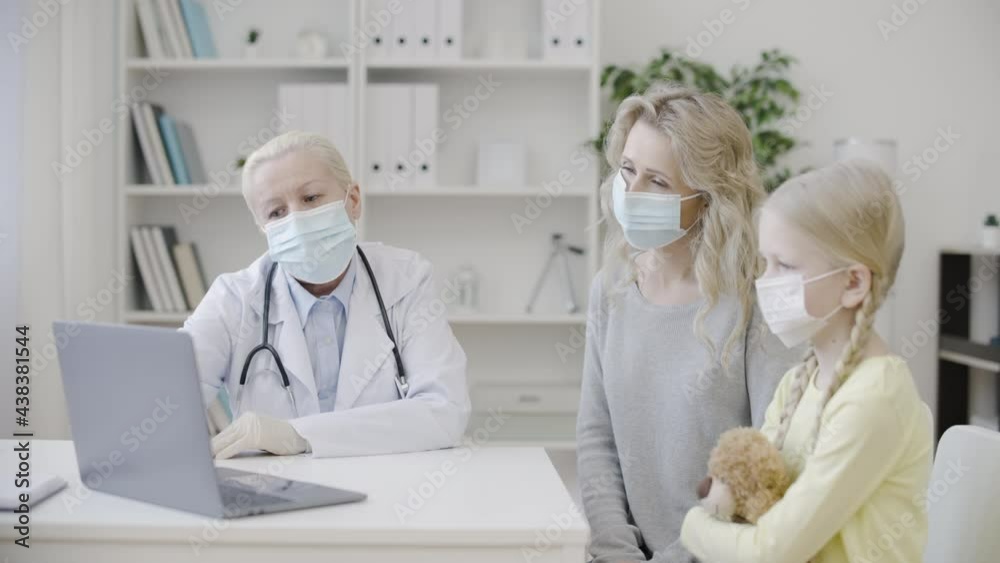 Physician showing mother and child test results on laptop pc, health care Physician showing mother and child test results on laptop pc, health care