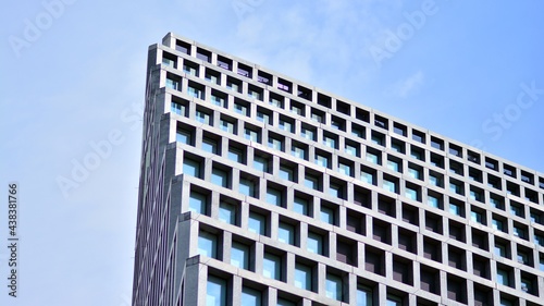 Abstract image of looking up at modern glass and concrete building. Architectural exterior detail of office building. Industrial art and detail. Sunrise.