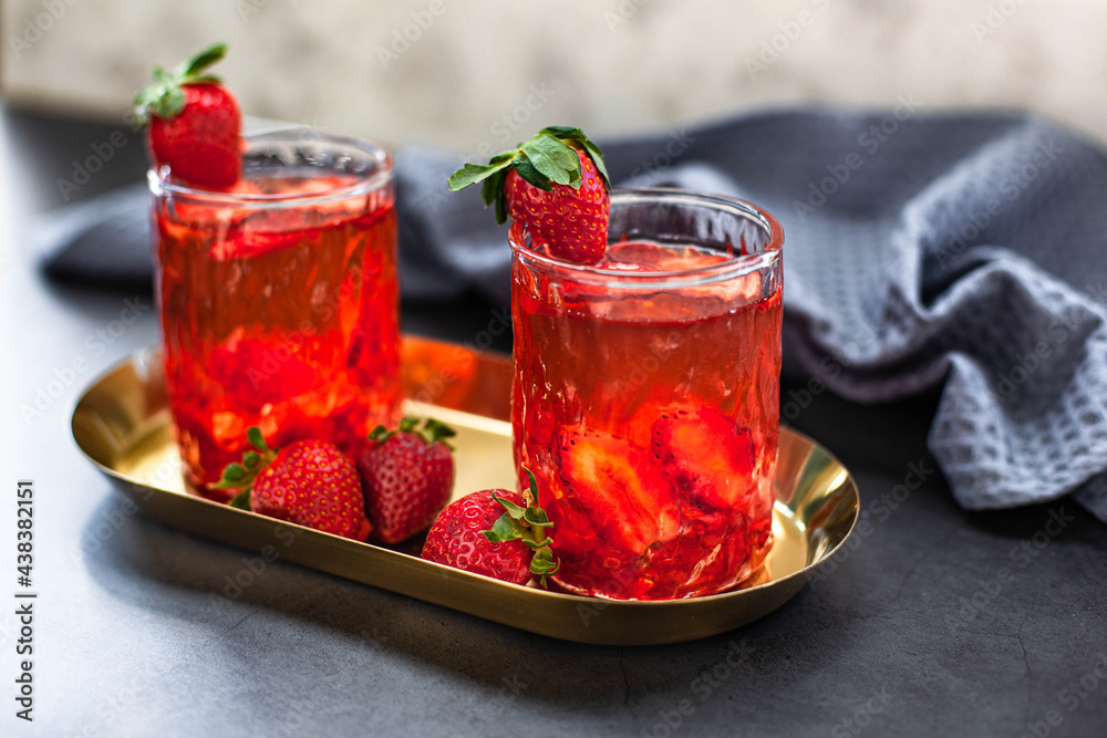 Red drink with ice and strawberry with leaves Red drink with ice and strawberry with leaves