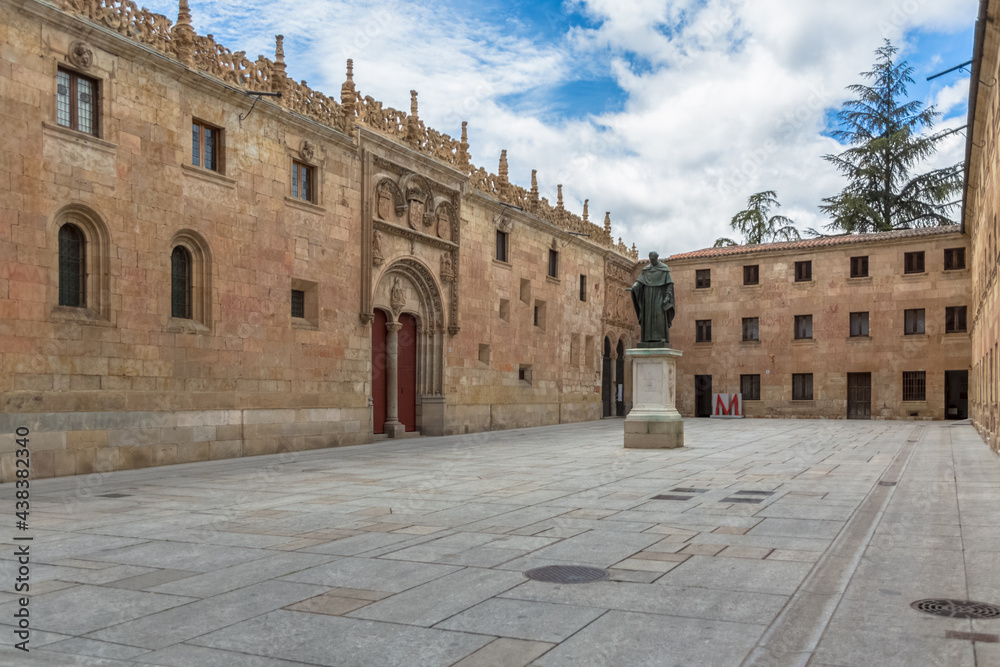 View at the patio de escuelas, central University plaza with Salamanca Museum and University of Salamanca buildings and Fr Luis de Leon statue