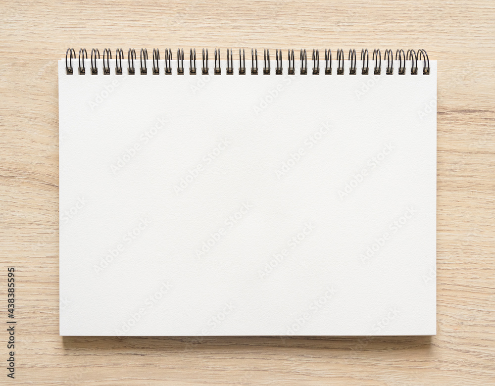 Blank spiral bound notepad mockup template with Kraft Paper cover, isolated on wood background. Blank spiral bound notepad mockup template with Kraft Paper cover, isolated on wood background.
