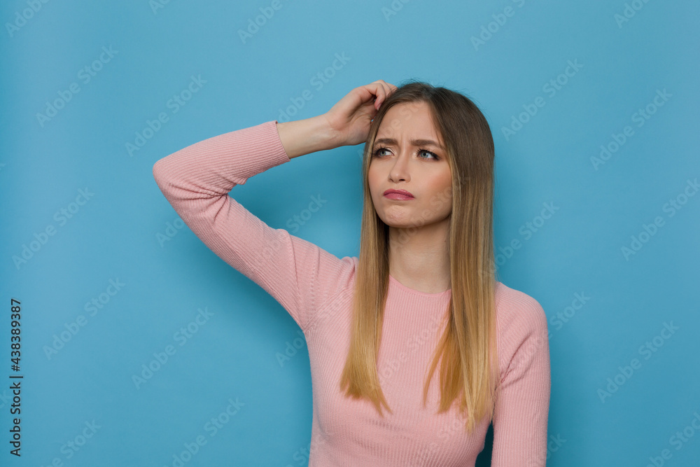 Young Woman Is Scratching Her Head And Thinking
