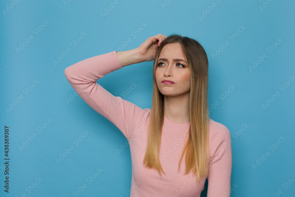 Young Woman Is Scratching Her Head And Thinking Young Woman Is Scratching Her Head And Thinking