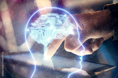 Double exposure of man s hand holding and using a digital device and brain hologram drawing. Data concept.