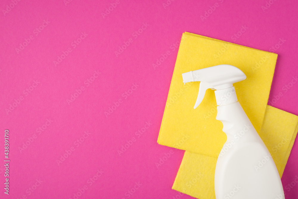 Top view photo of white spray detergent bottle without label and two yellow viscose rags on isolated pink background with copyspace Top view photo of white spray detergent bottle without label and two yellow viscose rags on isolated pink background with copyspace