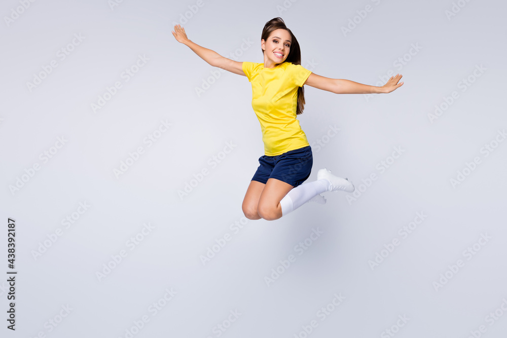 Full size photo of cheerful professional soccer player girl jump enjoy play football world championship cup wear kit white socks shoes boots isolated over grey color background