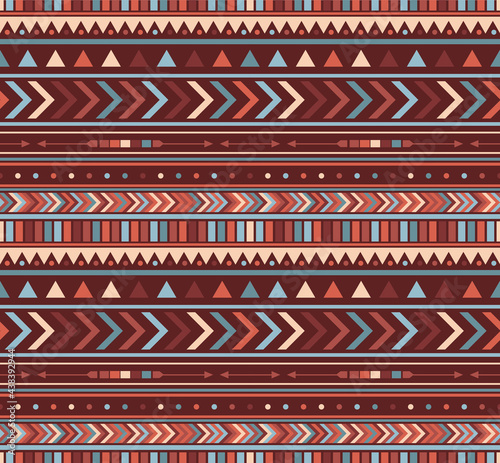 vector seamless ethnic geometric pattern in contrast orange and blue palette, main colour is orange